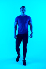 Its about putting one foot in front of the other. Studio portrait of a handsome young male athlete posing against a blue background.
