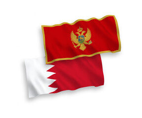 National vector fabric wave flags of Montenegro and Bahrain isolated on white background. 1 to 2 proportion.