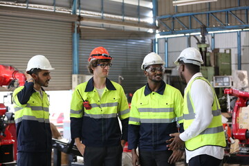 engineer checking control panel and teaching new Automatics robot arm and operating control machine in factory.