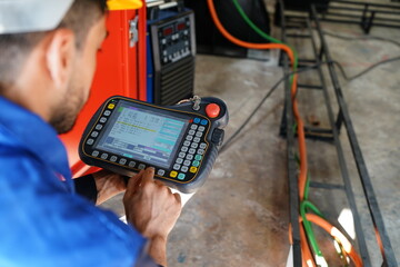 Engineer check and control welding robotics automatic arms machine in intelligent factory...
