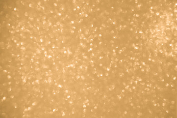 Gold glitters background. shimmering blur spot lights Bokeh Shiny gold light background.