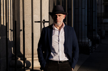 Portrait of adult man in hat and suit on street. Madrid, Spain