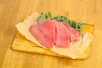 Raw salted tuna slice over board