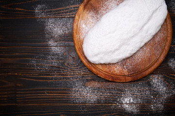 Traditional Christmas stollen cake with marzipan and dried fruit isolated on wooden background