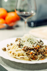 Pasta bolognese with a glass of pinotage red wine. Wine from the Pinotage grape variety. Italian cuisine at home. Dishes of Italian cuisine with your own hands.