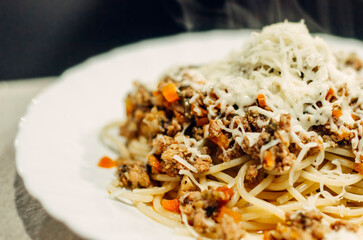 Pasta bolognese with a glass of pinotage red wine. Wine from the Pinotage grape variety. Italian cuisine at home. Dishes of Italian cuisine with your own hands.