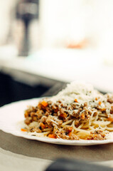 Pasta bolognese with a glass of pinotage red wine. Wine from the Pinotage grape variety. Italian cuisine at home. Dishes of Italian cuisine with your own hands.