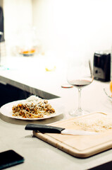 Pasta bolognese with a glass of pinotage red wine. Wine from the Pinotage grape variety. Italian cuisine at home. Dishes of Italian cuisine with your own hands.