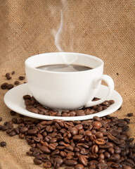 Burlap background with coffee cup and coffee beans