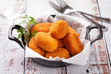 Tapa of croquettes on white table
