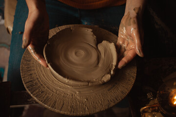 woman makes plate of clay in pottery workshop, beautiful background, authentic atmosphere,...