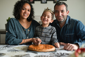 Family in front of a king cake