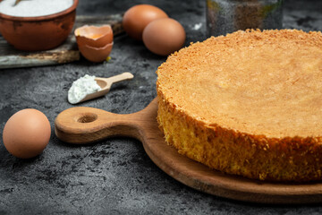 Homemade sponge cake on wooden table, Bakery background. Culinary, cooking, bakery concept. place for text, top view