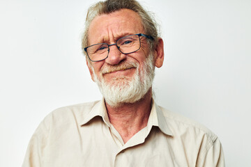 Portrait of happy senior man with a gray beard in a shirt and glasses isolated background
