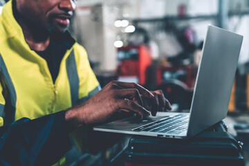 Factory worker working with laptop computer to do adept procedure checklist . Factory production line operator occupation quality control concept .