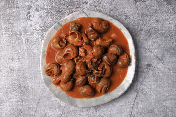 Serving of stewed snails in sauce