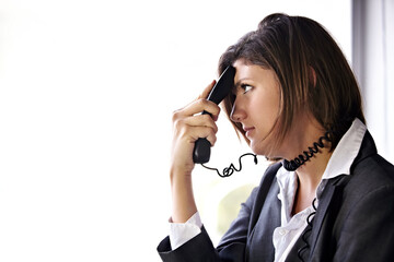 The call that ruined her day.... A bored businesswoman with a phone pressed to her head and the...