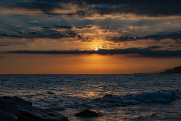 Fototapeta na wymiar Sea against picturesque golden cloudy sky sunset on an amazing beach wallpaper