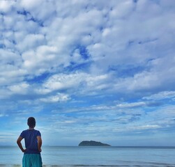 person on the beach watching the sea.