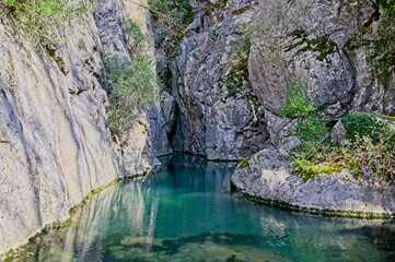 Fototapeta na wymiar Blue Green River in a Rocky Canyon in the Mountains of Umbria Italy