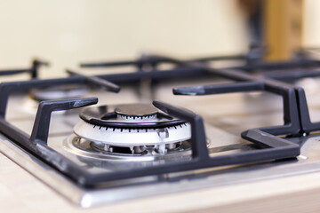Fototapeta na wymiar Gas stove burner close-up on a blurred background