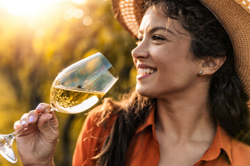 Happy woman in the vineyard,drink wine
