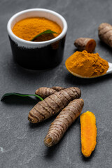 curcuma or curcumin root. Turmeric powder and fresh turmeric. on concrete background. Spice, natural coloring, alternative medicine. vertical image. top view