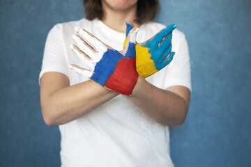 Peace symbol dove made from female hands colored in russian and ukraine flags colors. No war, stop...