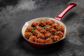 Traditional spicy meatballs in sweet and sour tomato sauce. Restaurant menu, dieting, cookbook recipe top view