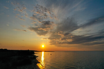 Beautiful orange sunset over the water. The Gulf of Finland. Coastal area Aerial view Coastline