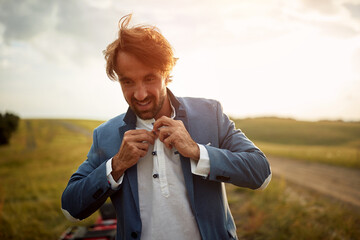 Close-up of a young groom preparing for a weding ride with the quad in the nature. Riding, wedding, nature, activity © luckybusiness