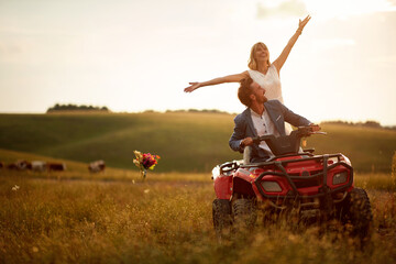 Happy young newlyweds are in a good mood while having a quad ride in the nature. Riding, wedding, nature, activity