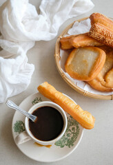 Popular Malaysian Chinese street food. Black Coffee and Deep Fried  Youtiao aka Fried Fritters. Comes with many variety and taste, some with fillings or plain and goes well with black or milk coffee