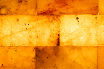 Salt bricks close up. Illuminated salt bricks in the sauna, background, texture
