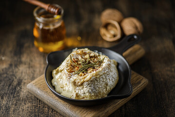 baked brie cheese on a wooden board
