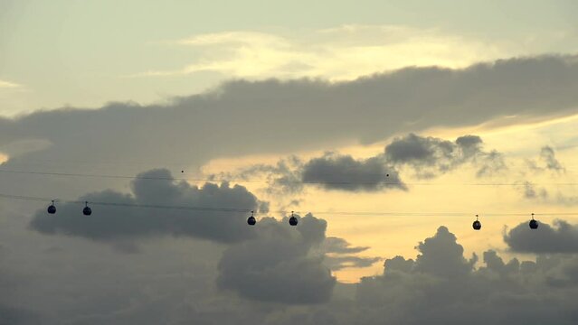 Silhouette of Singapore Ski elevator cableway transportation to Sentosa island on the evening