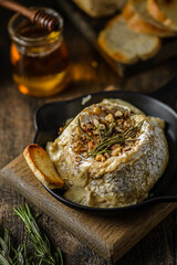 baked brie cheese on a wooden board