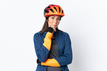 Young cyclist brazilian girl isolated on white  background thinking an idea