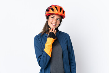 Young cyclist brazilian girl isolated on white  background looking up while smiling