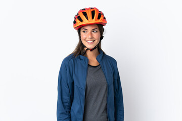 Young cyclist brazilian girl isolated on white  background looking to the side and smiling - obrazy, fototapety, plakaty