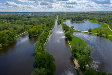 A panoramic view from a height of the ponds and the Landscape Park in Peterhof, the meadow garden, walking paths, the destroyed pavilion.