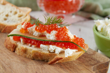 Red caviar on a wooden table, bruschetta with caviar