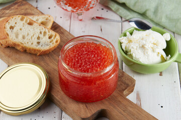 Red caviar on a wooden table, bruschetta with caviar