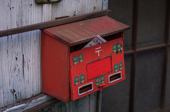 red japanese post box of an abandoned house