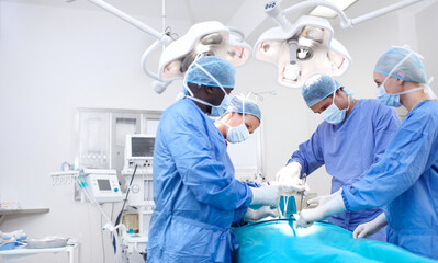 Let your copyspace tell families the good news. Meidcal surgeons performing surgery in an operating...