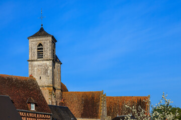 Fototapeta na wymiar Spring image of the tower of the church from Brou a small town located in Eure et Loir Department in Central France. 