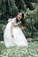 girl in communion dress in the garden