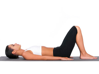 Plakat Breathing in deeply. A young woman doing stretches while isolated on white.