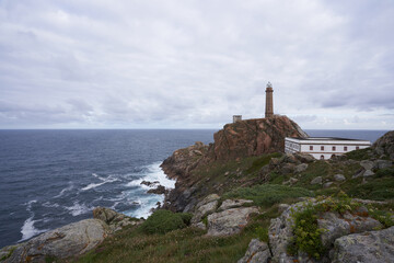 Dramatic gloomy view of the Cape Vilano lighthouse in a privileged natural environment on the cliffs.