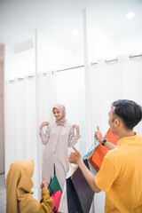 Fototapeta premium muslim woman trying dress in fitting room